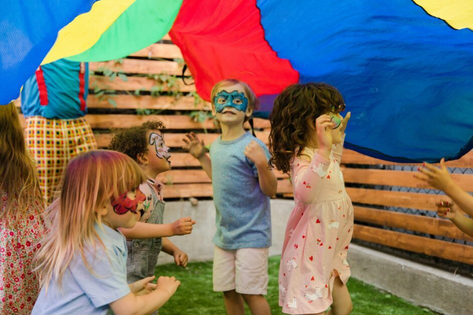 Backyard Entertainment and Hosting System. Children with face paint enjoying an outdoor party with vibrant colors and playful activities.