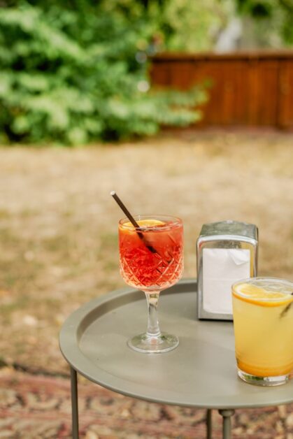 Drinks Backyard Setup: A table with two glasses of drinks on it